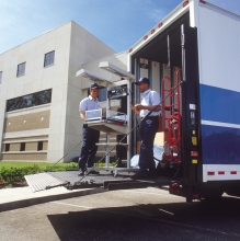 A mendical machine staged for moving off of a lift gate moving van