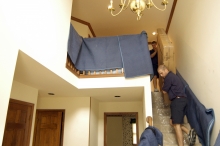 Moving a packed mattress carton down a set of stairs
