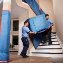 Carrying a pad-wrapped dresser down a stairway
