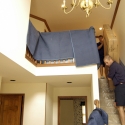 Moving a packed mattress carton down a set of stairs Moving a packed mattress carton down a set of stairs